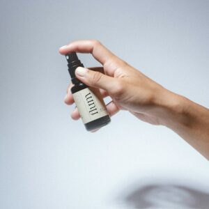 a hand holding a small black device